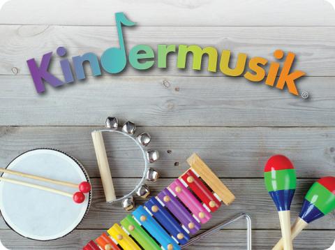 logo of the kindermusik program with a picture of instruments on the floor