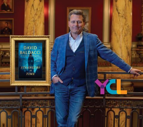 author david baldacci leaning against a balcony in a theatre