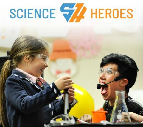 image of woman and little girl doing a science experiment smiling and look very excited. The logo for "science heroes" is seen above the picture.