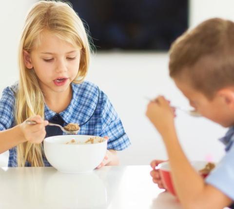 children eating a bowl of cereal