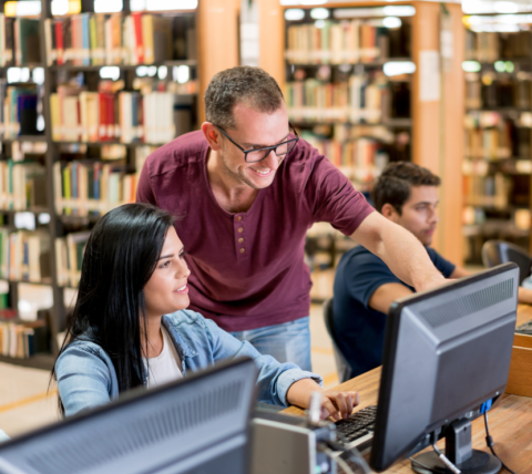 woman and man at computer monitor
