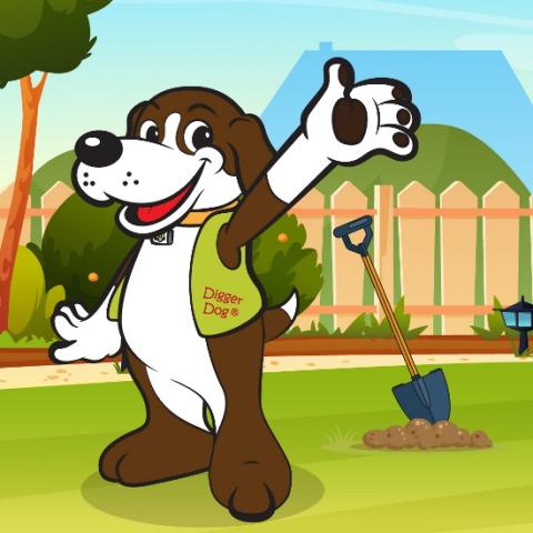 Digger Dog mascot with a shovel in a yard