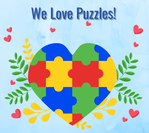 Jigsaw pieces formed into a heart with the title of We Love Puzzles!