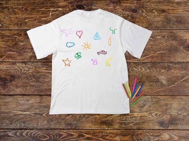 design your own t-shirt. graphic of a white t shirt with artistic doodles on the front of it. 