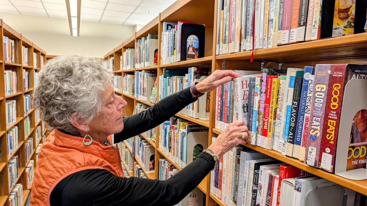 Volunteer shelving books in the library