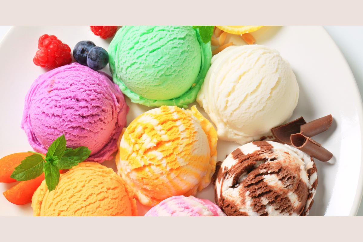 Pink, green, white, and yellow ice cream on a plate