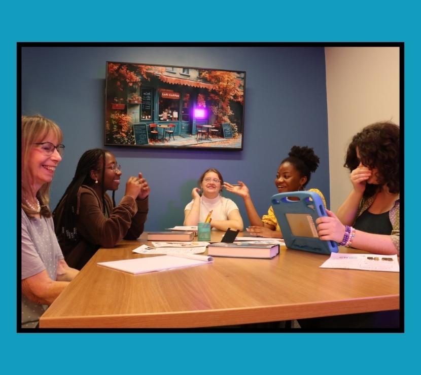 Five females at a table talking