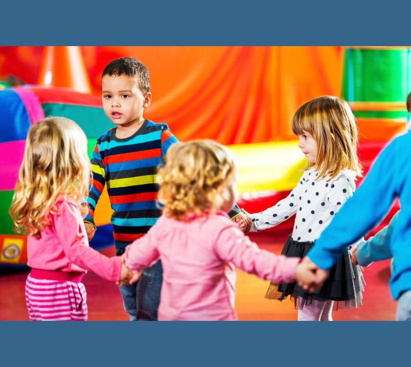 children standing in a circle holding hands on a colorful background